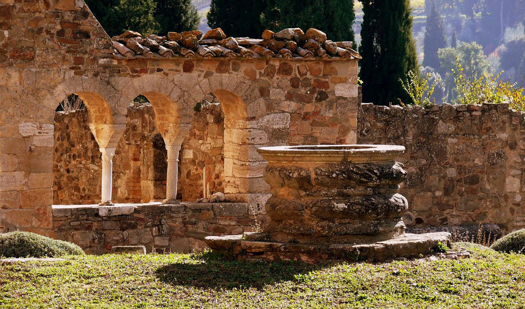 Esterno del Monastero do Sant'Antimo si vede un lato della vecchia chiesa e il pozzo